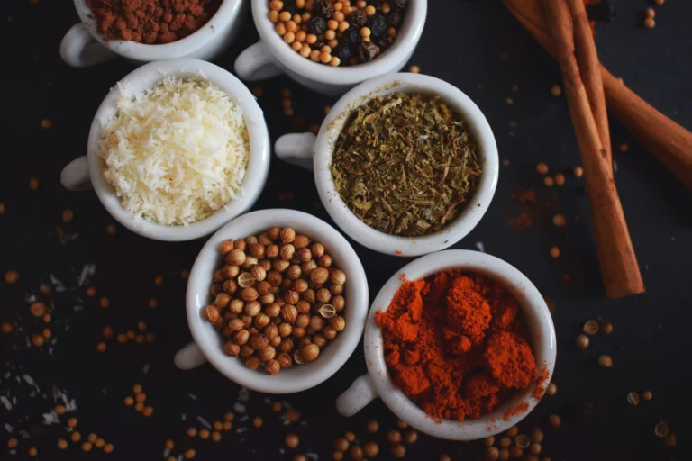 Assorted spices displayed in small bowls with vibrant colors and textures