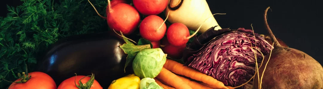 Assorted fresh vegetables arranged on a table with vibrant colors and variety