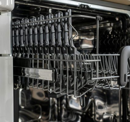 A detailed view of an empty modern dishwasher rack showcasing its stainless steel construction.